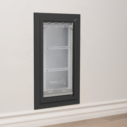 A black-framed "Endura Flap Pet Doors" pet door is installed in a wall.