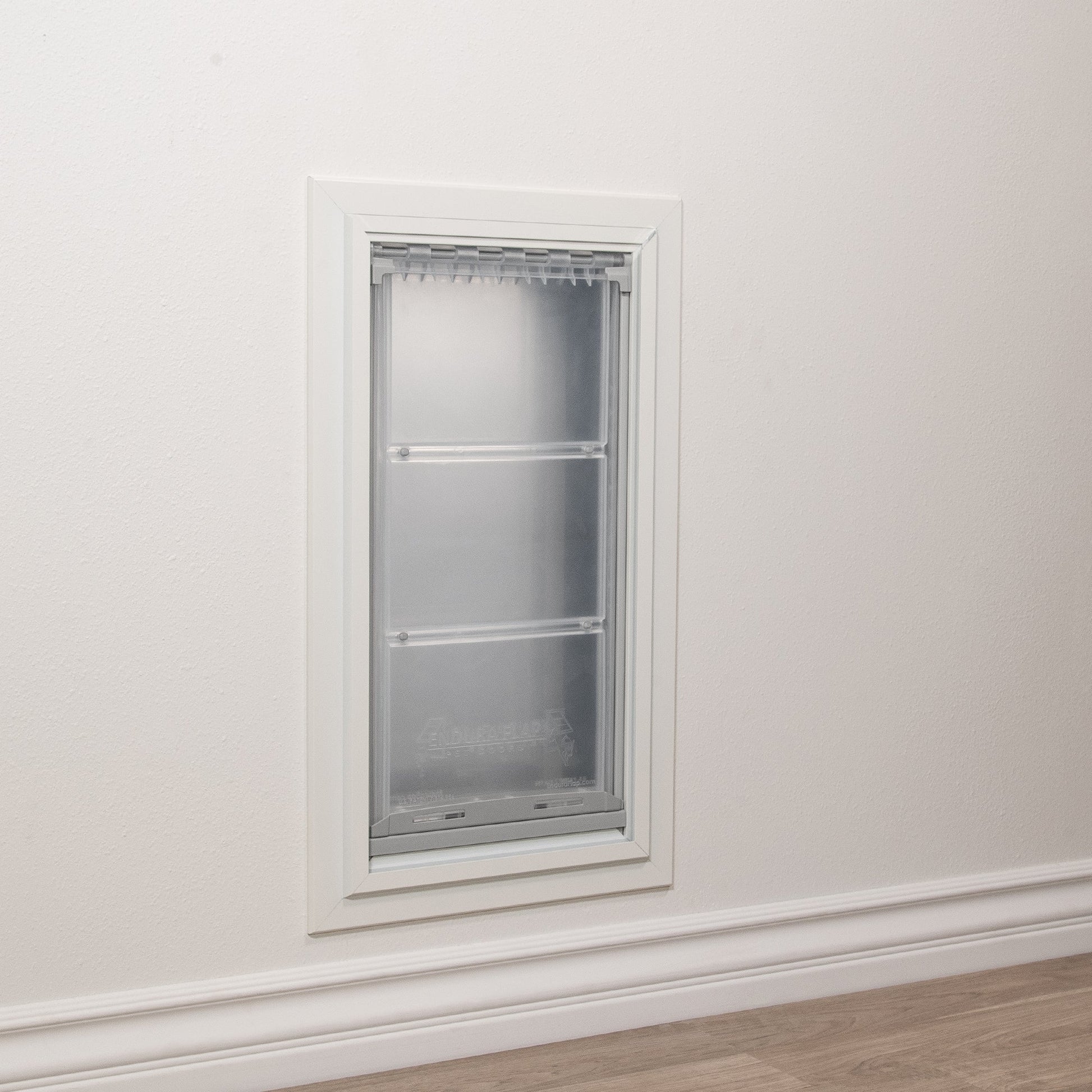 A pet door is installed in a wall.