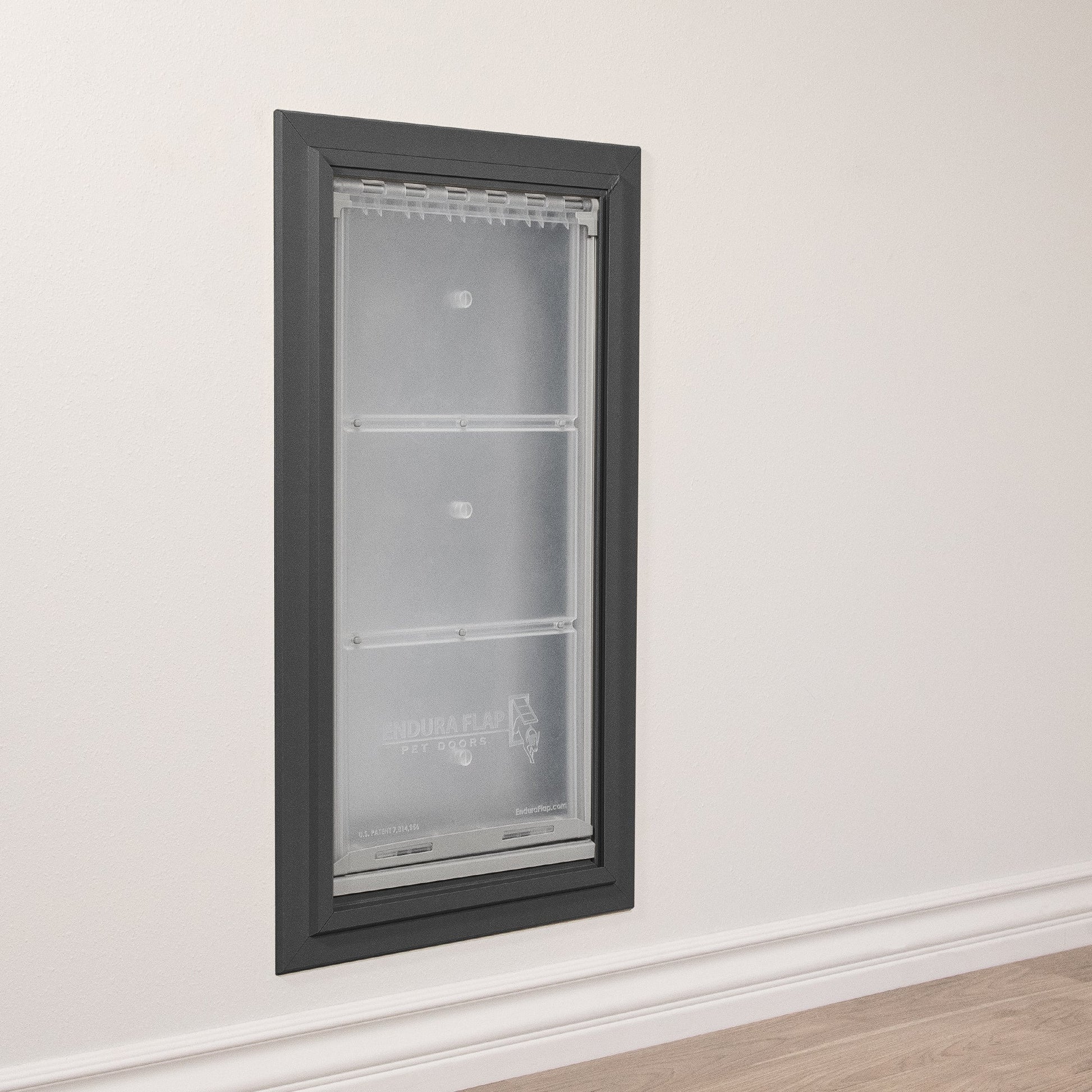 An "Endura Flap Pet Door" is installed in a wall.