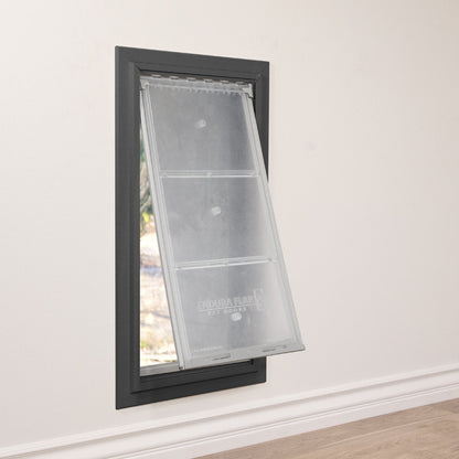 A pet door with a transparent flap is installed in a wall.