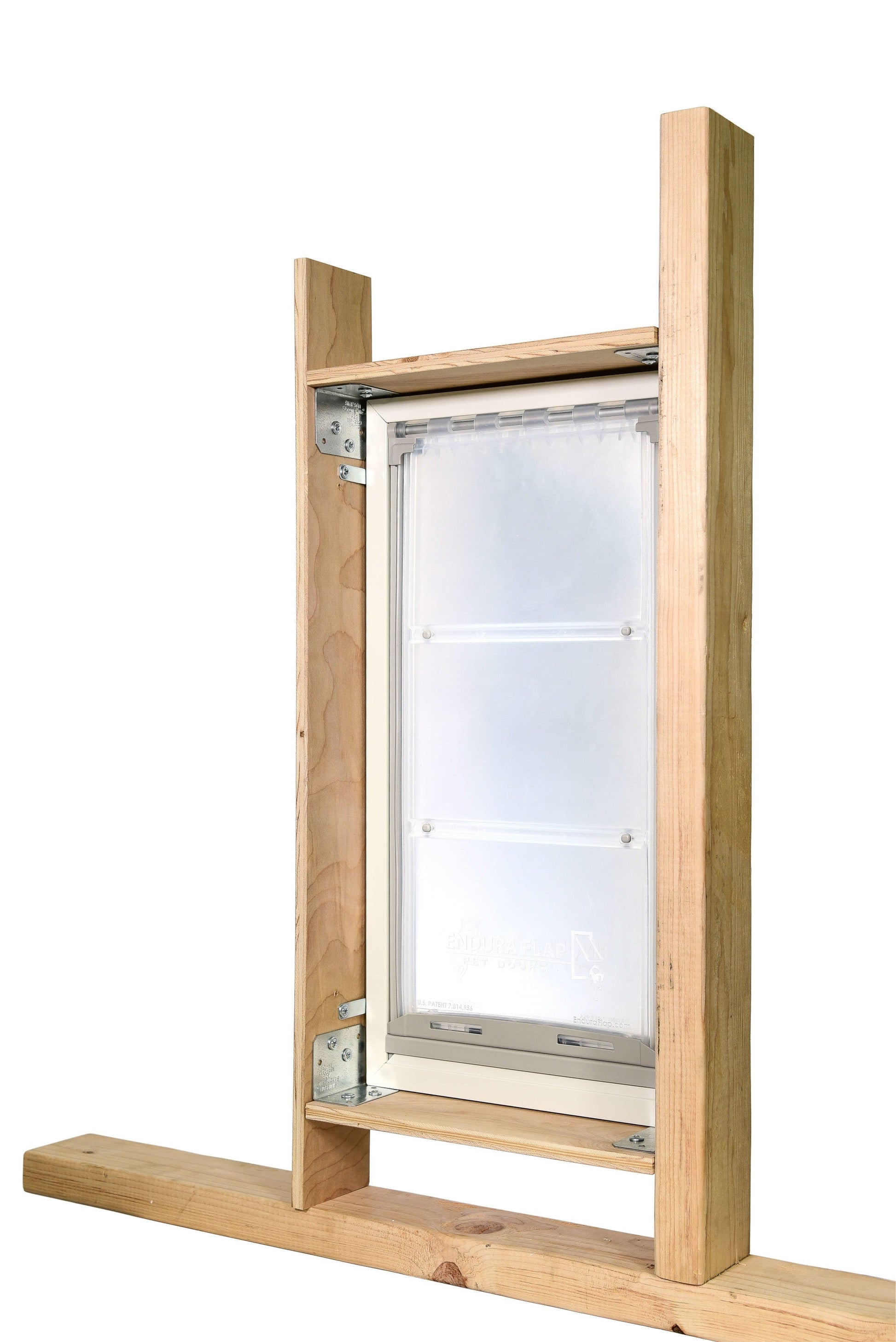 An Endura Flap pet door is installed in a wooden frame.